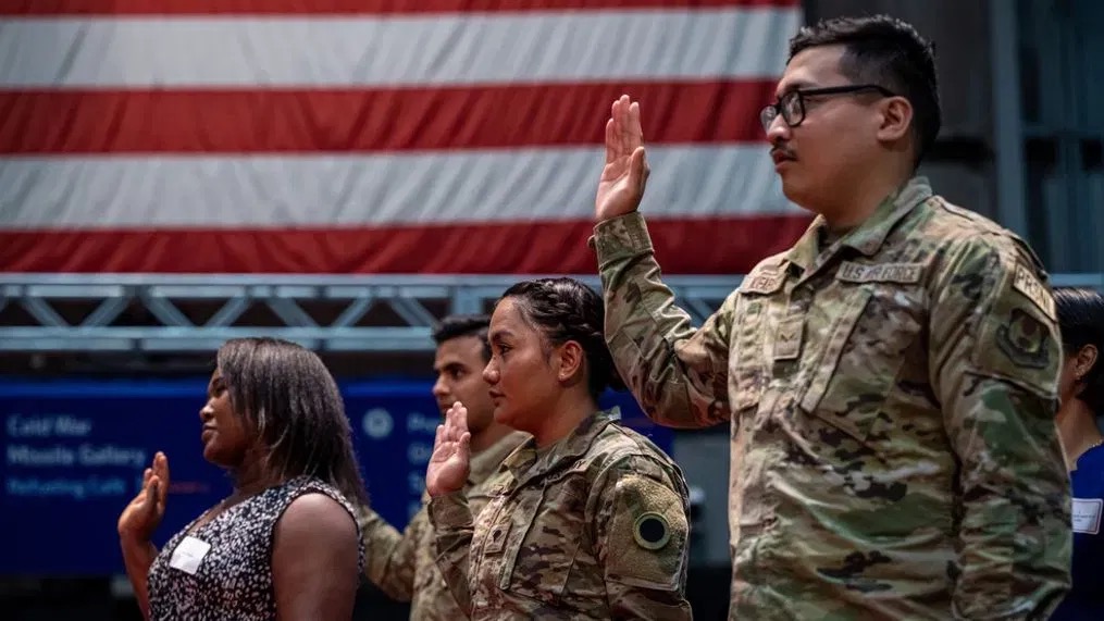 U.S. soldier saluting with American flag and passport - Citizenship through military service